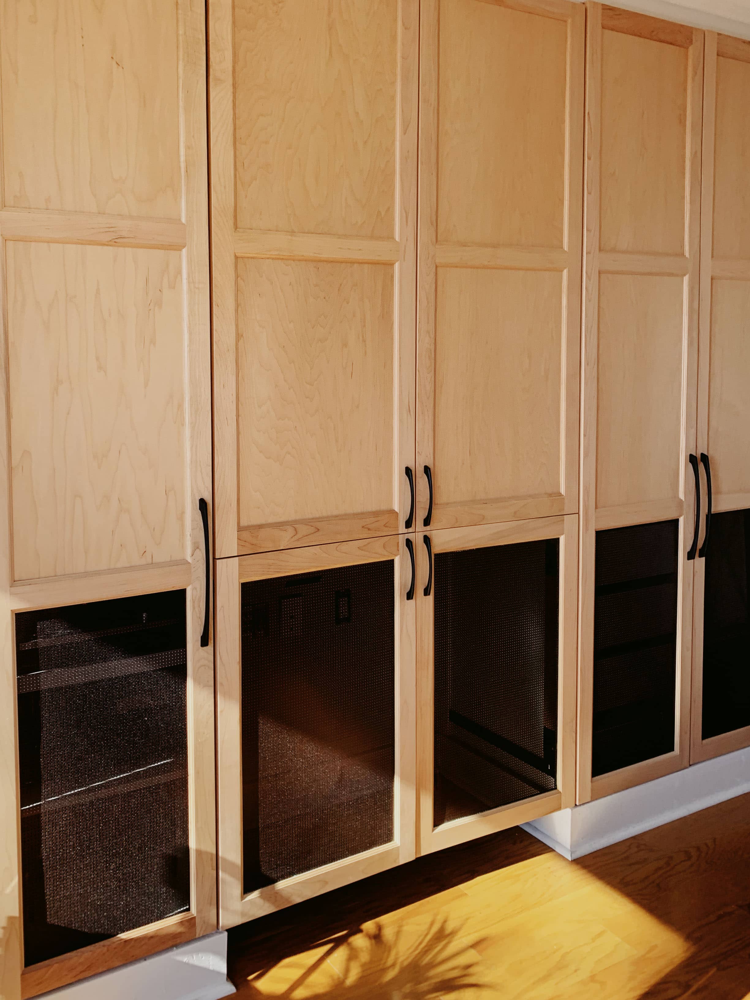 Custom wet bar with dark espresso cabinetry, diamond wine racks, glass-front cabinets, and granite countertop by GM Cabinetry