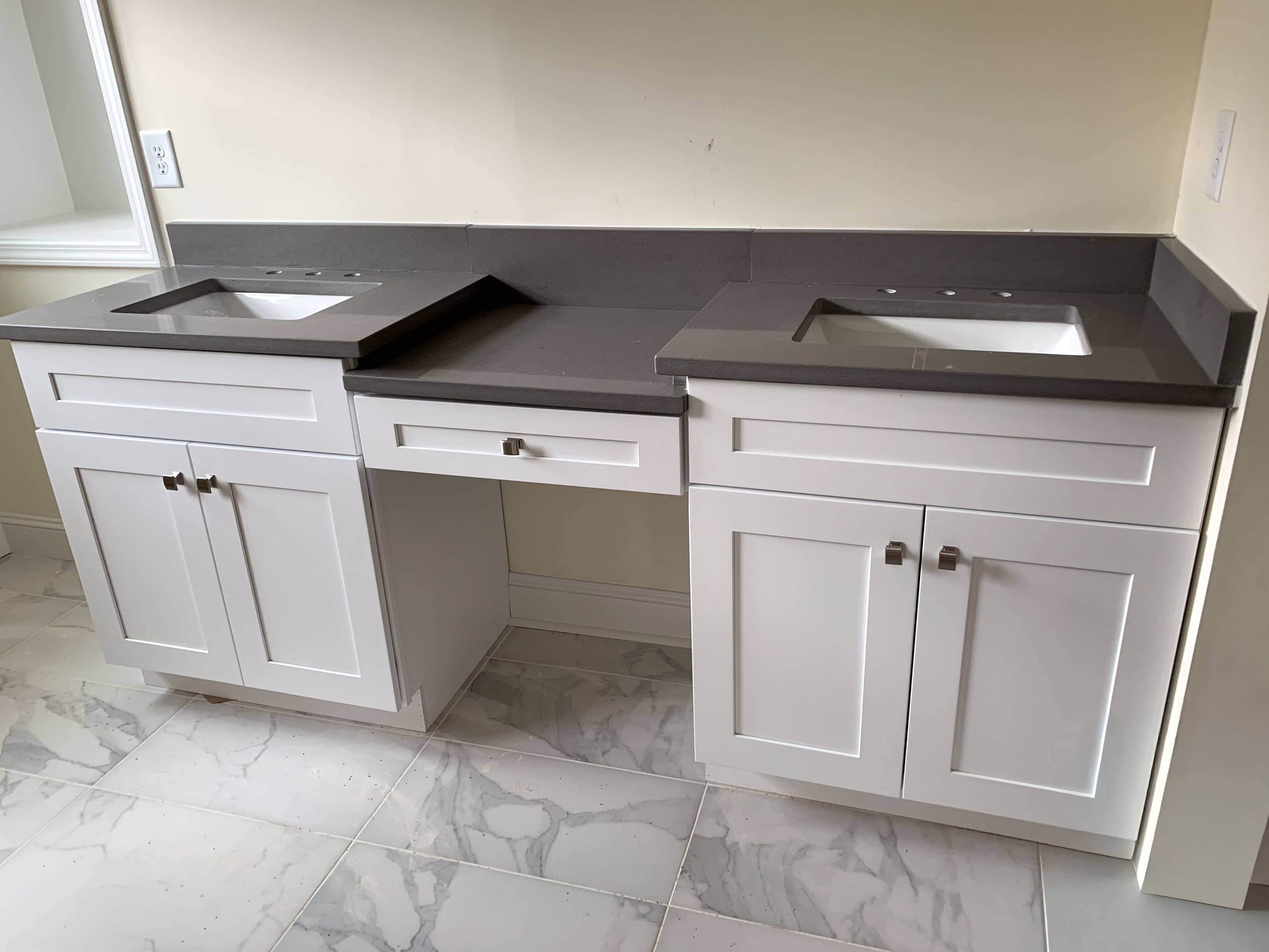 Custom white shaker double bathroom vanity with grey quartz countertop and undermount sinks by GM Cabinetry