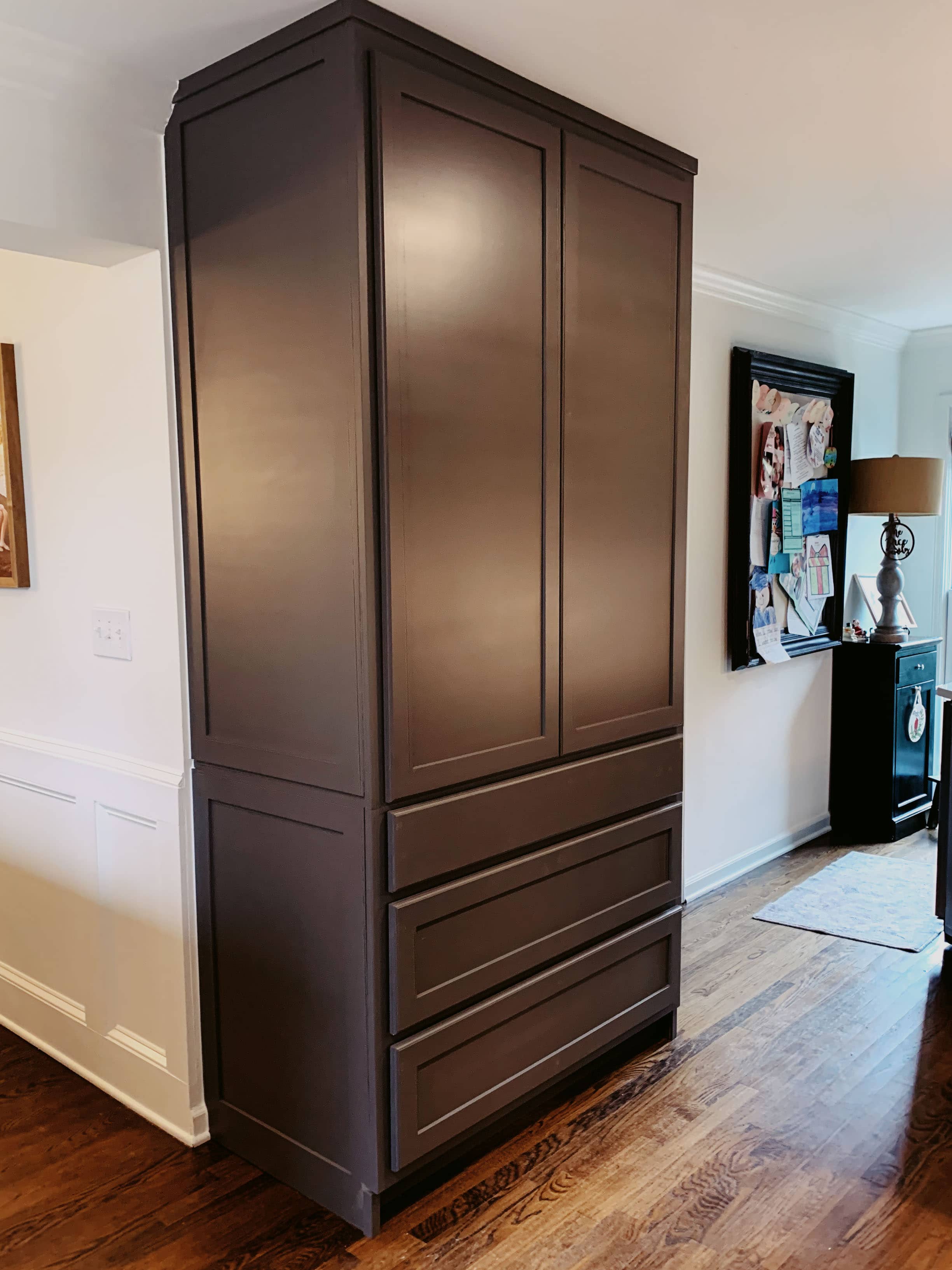 Custom wet bar with dark espresso cabinetry, diamond wine racks, glass-front cabinets, and granite countertop by GM Cabinetry